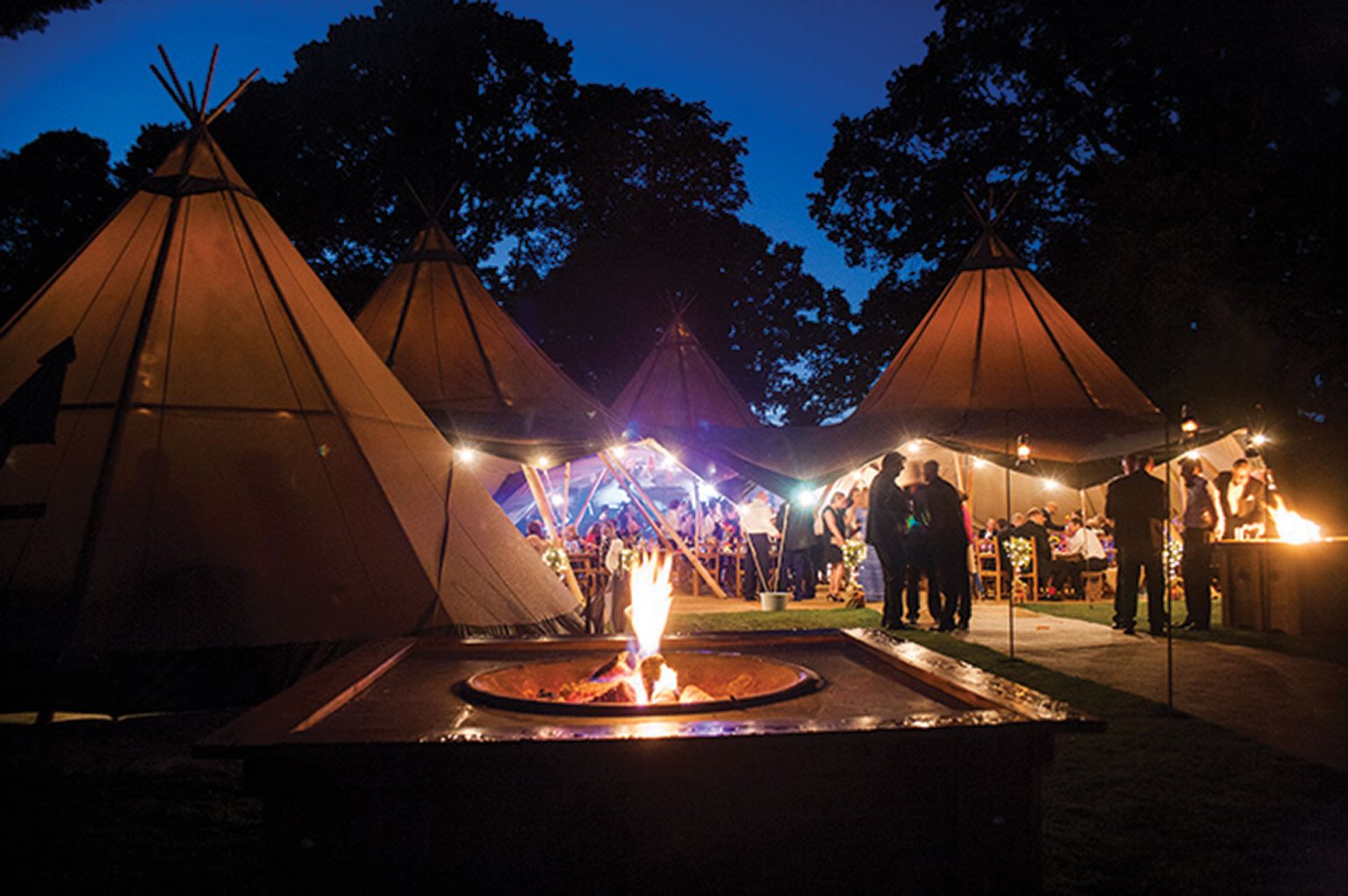 Fire tipis people party gathering evening