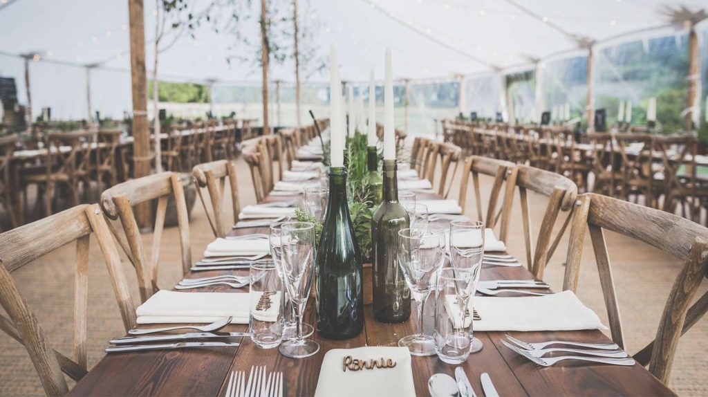 Dressed tables under a sailcloth tent