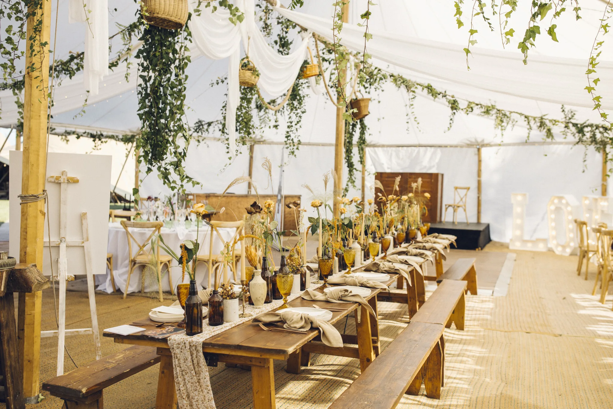 dressed rustic table in a luxury Sailcloth marquee tent