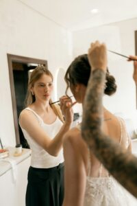 Make up artist getting bride ready for a wedding