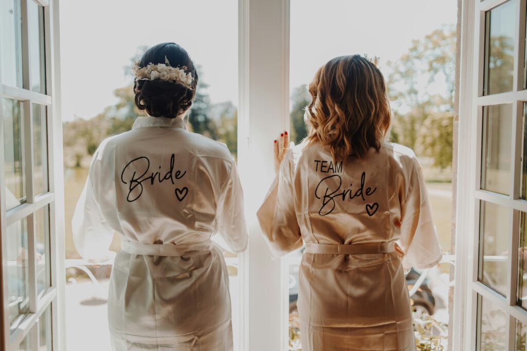 Bride and bridesmaid getting ready