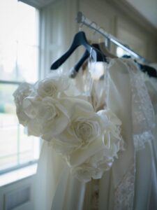 Wedding dress in the background with satin flower headdress