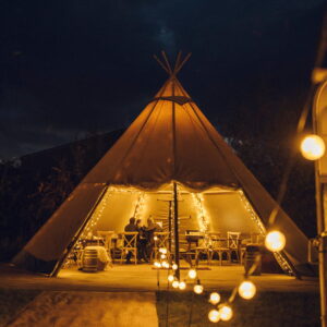 Kung tent lit up for a winter party at night