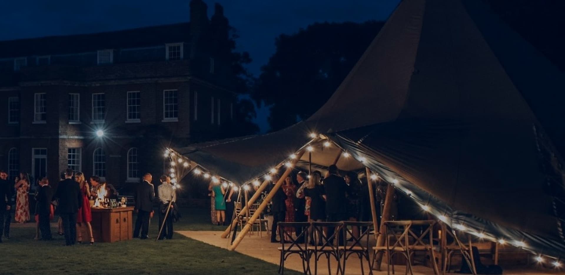 Winter tipi hire at a country house: a single tipi lit up on a frosty night
